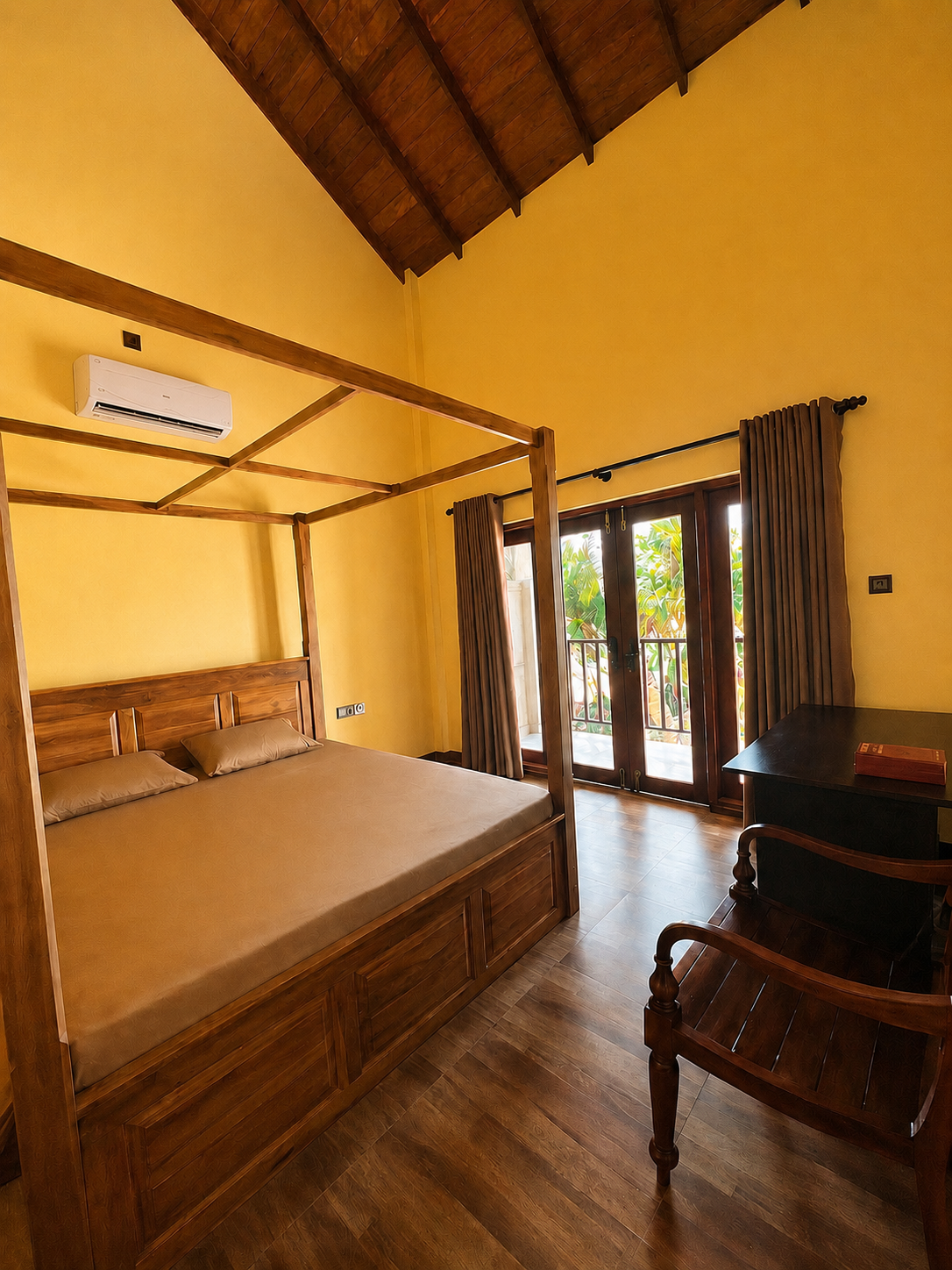 CocoBaru wooden canopy bedroom with balcony doors and warm timber ceiling